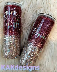 two personalized glitter tumbles are sitting on a furry surface