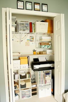 an organized home office area with shelves and drawers