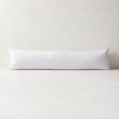 a white pillow sitting on top of a table