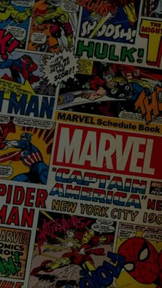 many different comics are spread out on the wall in front of them, including captain america and spider - man