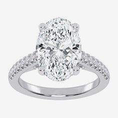 an oval cut diamond ring with pave set shoulders