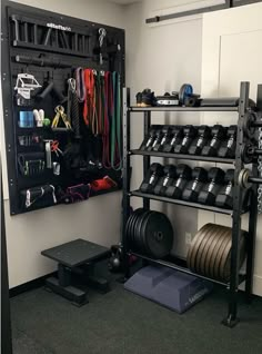 there is a rack with many different items in the room and one has a barbell on it