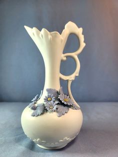 Hello, and thanks for looking! The item for sale: Vintage Ewer Bud Vase, most probably made by Andrea By Sadek, Raised Applied Flowers measures 7.25 in tall x 4 in diameter and weighs 11 oz. Please see the pictures for more details and ask if you need clarification. I offer a few different shipping options - check them out before purchasing. Pictures are of the actual item(s) that we are selling. It comes from a non-smoking environment and has been stored for several months.  All items are being sold as found so minor cleaning may be desired.   We have other unique & interesting items that may be of interest!  Please check them out as we're constantly adding new items. Add us as your favorite seller!  Orders can be shipped within the 48 states in the continental U.S. Additional fees are re Vase Vintage, Bud Vase, Flower Vase, Bud Vases, White Ceramics, New Items, Vase, How To Apply, Things To Come