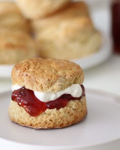 biscuits with jam and cream are on a plate