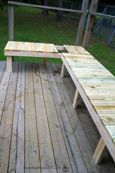 two wooden benches sitting on top of a wooden deck