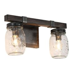 two mason jar lights are mounted on the wall in this rustic bathroom vanity light fixture