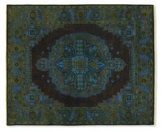 an antique rug with blue and green colors on the bottom, surrounded by ornate designs