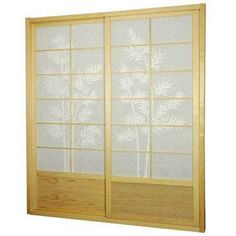 an open wooden door with frosted glass on the doors and side panels, in front of a white background