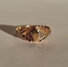 A lovely little vintage signet ring with the shield shaped and engraved to look like a little leaf. Made in 14k gold and size Ø18,3 mm/US 8,25. The signet plate measures 6,3*3,7 mm. Shank width 8,3-1,9 mm and the motif comes 2,5 mm off the finger when wearing. There are hallmarks on the outside of the shank. Very good vintage condition, the engraving on the signet is somewhat faint but other than that there is barely any wear. Remember: Vintage and antique jewelry are sustainable, eco-friendly a Luxury Vintage Open Signet Ring, Vintage Oval Signet Ring With Diamond Cut, Vintage Oval Diamond Cut Signet Ring, Vintage 14k Gold Diamond-cut Signet Ring, Vintage 14k Gold Diamond Cut Signet Ring, Vintage 14k Gold Signet Ring With Diamond Cut, Vintage Tarnish-resistant Signet Ring For Promise, Vintage Tarnish Resistant Signet Ring For Promise, Antique 14k Gold Diamond Cut Signet Ring