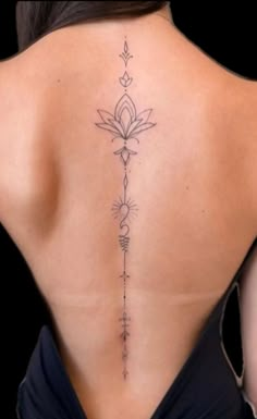 the back of a woman's body with tattoos on her upper and lower back