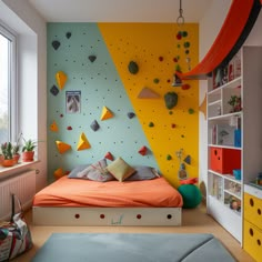 a child's bedroom with climbing walls and colorful bedding