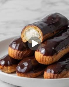 a white plate topped with chocolate covered donuts