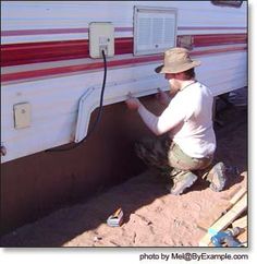 a man is working on the side of a trailer