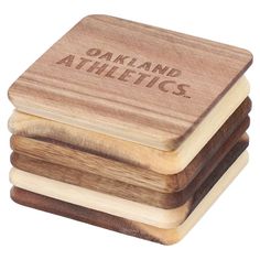 three wooden coasters with the words oakland athletics engraved on them, stacked in front of each other