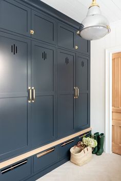 a kitchen with blue cabinets and gold handles on the doors is pictured in this image