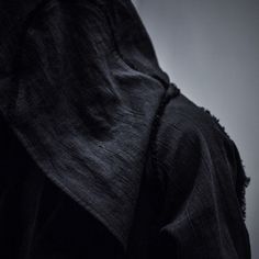 a person wearing a black veil and holding a cell phone