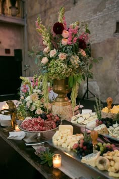 the table is full of different types of food and flowers on it's display