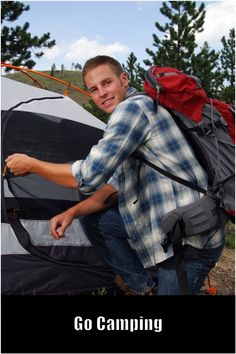 a man standing in front of a tent with the words go camping written on it