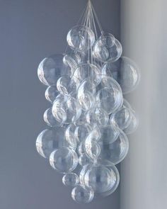 a chandelier made out of clear bubbles hangs from a ceiling in a room