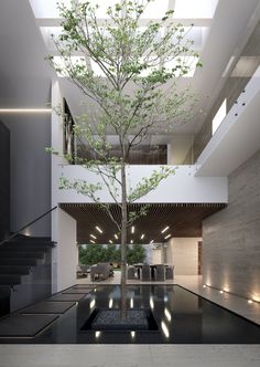 a tree is in the middle of a room with stairs and lights on either side