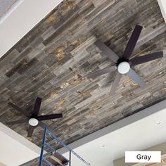 a ceiling fan mounted to the side of a wooden plank ceiling in a living room