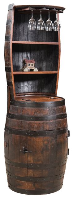 an old wooden barrel with wine glasses on top