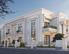 a large white building with balconies on the second floor and two story windows