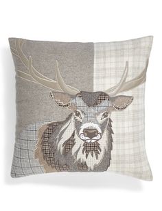 a decorative pillow with a deer head on the front and plaid pattern on the back