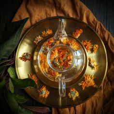 a glass plate with dried flowers in it