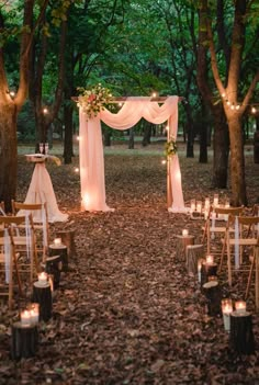 an outdoor wedding set up in the woods