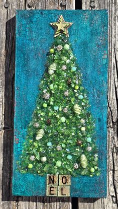 a painting of a christmas tree on a wooden board