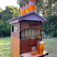 a beehive with honey in jars on top