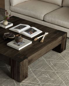 a coffee table with books and magazines on it