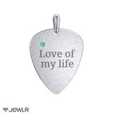 a guitar pick with the words love of my life engraved on it