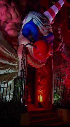 the clown statue is lit up in red, white and blue