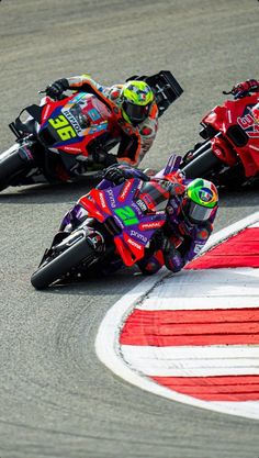 two motorcyclists are racing on the track