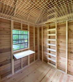 an empty room with wood paneling and a window