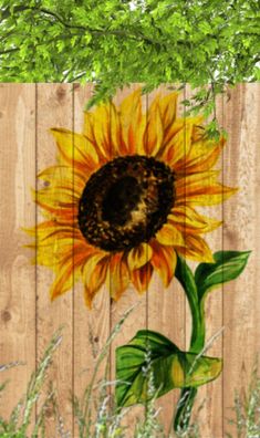 a painting of a sunflower on a wooden fence