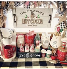 a coffee bar with hot cocoa and candy canes on the counter next to a christmas sign