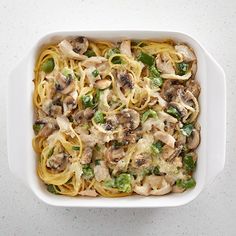 a casserole dish with noodles, mushrooms and green peppers in a white bowl