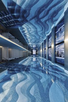 an indoor swimming pool with blue and white designs