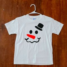 a white t - shirt with a snowman face on it