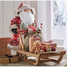 a santa clause sitting in a sleigh with presents