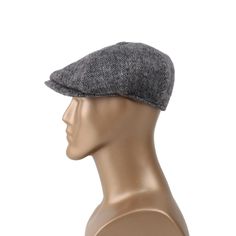 a mannequin head wearing a gray hat