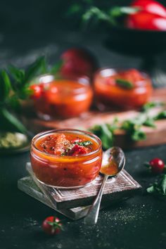 a small glass bowl filled with tomato sauce and garnished with parsley