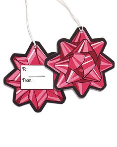 two ornament shaped like stars with a name tag attached to them