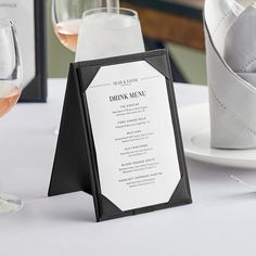 a table with wine glasses and menus on it