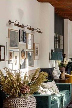 a living room filled with furniture and pictures on the wall