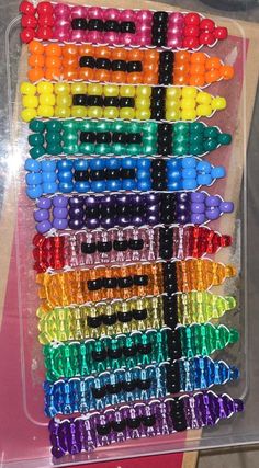 many different colored beads are in a plastic container