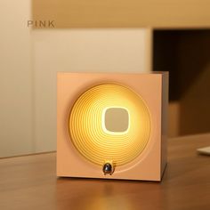 an electronic device sitting on top of a wooden table